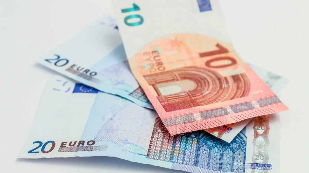 Stack of 10 and 20 euro banknotes symbolizing finance and economy.