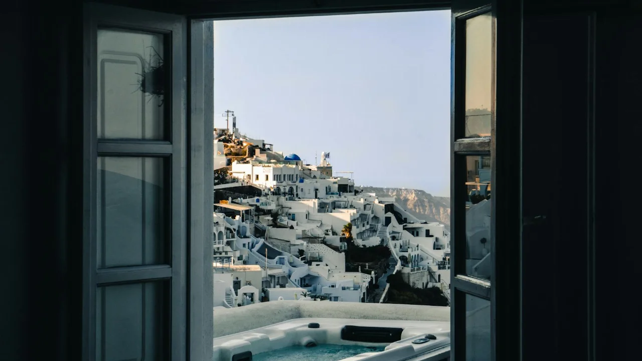 Experience the breathtaking architecture of Santorini through this open window view.